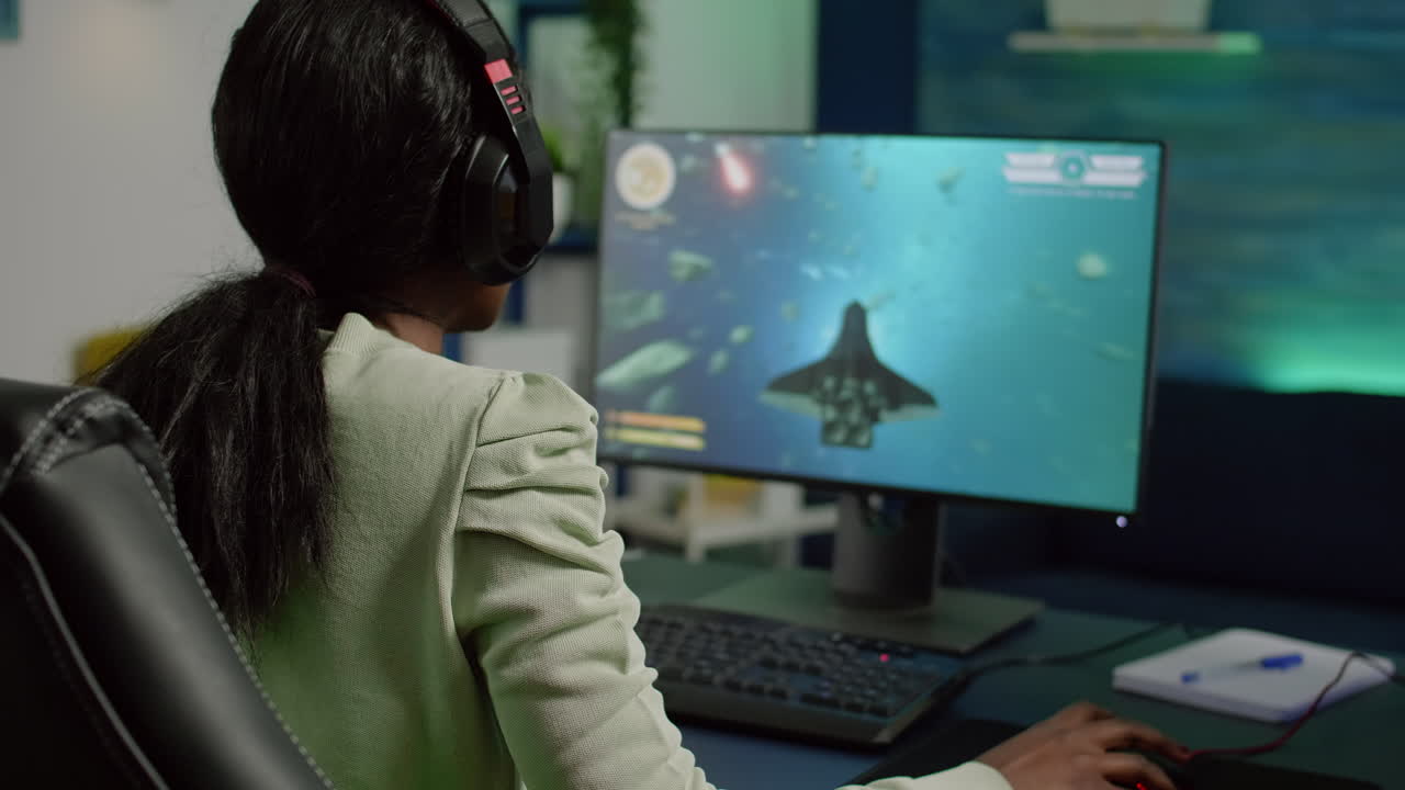 Excited african gamer with headphone winning important online game