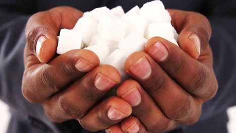 Hands-of-businessman-holding-sugar-cubes