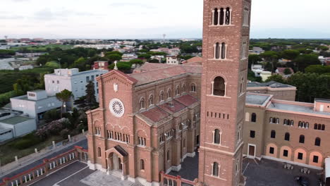 orbiting from left to right around an italian church at dusk