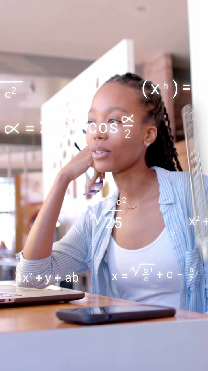 Vertical video: Woman holding specs speaking in cafe math overlay drifting over laptop studying