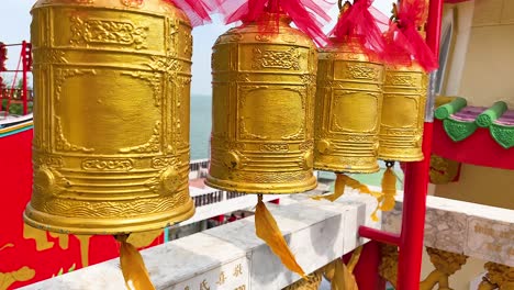 golden bells hanging in a vibrant temple