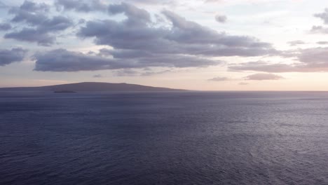 Aerial-wide-panning-shot-of-the-sacred-island-of-Kaho'olawe-and-Molokini-Crater-at-sunset-from-Wailea-in-West-Maui,-Hawai'i