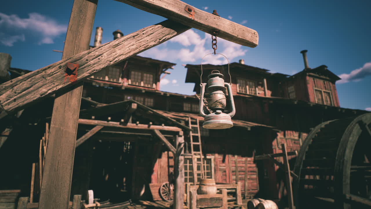 A rustic lantern hanging on a wooden post in an old western town at sunset