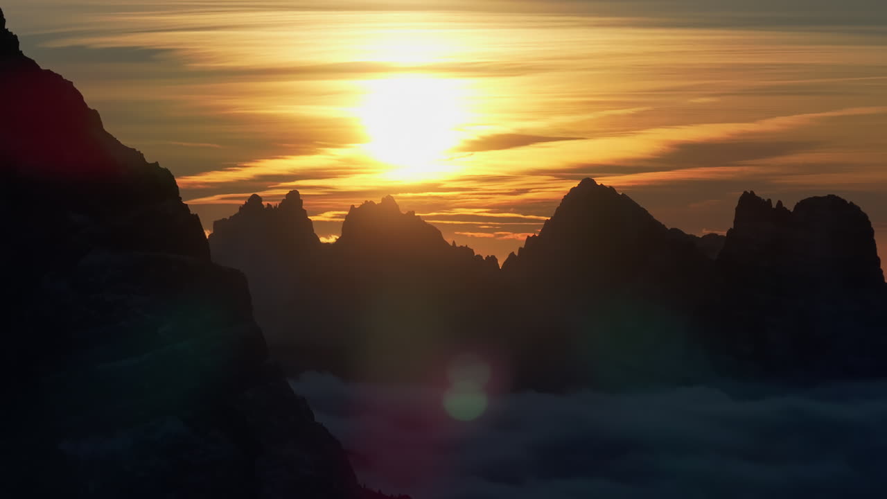 Aerial drone view of snow on the mountains in the Dolomites, Italy at sunset