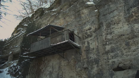 old balcony and cellar carved into the rock by millers in the former castle of harasov, czech republic - low angle medium slide tracking shot