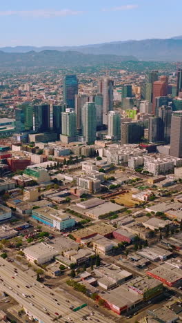 sunny urban american city. los-angeles aerial shot with skyscrapes. vertical video