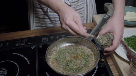 Adding-thyme-and-aromatic-herbs,-preparing-cafe-Paris-butter