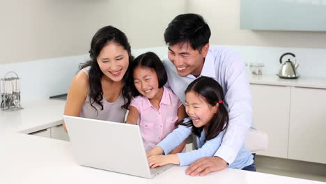 happy family using laptop together