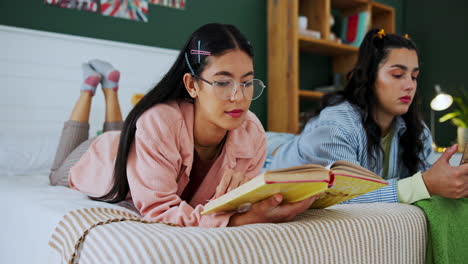 two women reading in bed