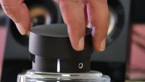 a man's hand mutes or unmutes the loudspeaker
