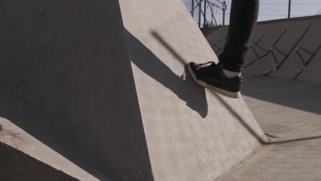 close up on the foot of someone testing the grip of a wall for a parkour jump under a beautiful sun in slow motion