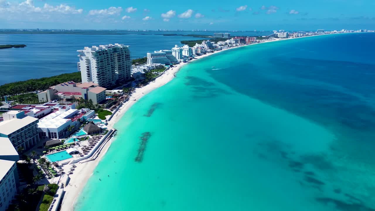 Drone aerial landscape coastline of Cancun with hotel resort swimming pool apartment units on beach with lagoon lake Mexico Playa Marlín Central America travel tourism