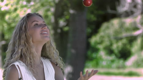 woman throwing an apple in slow motion