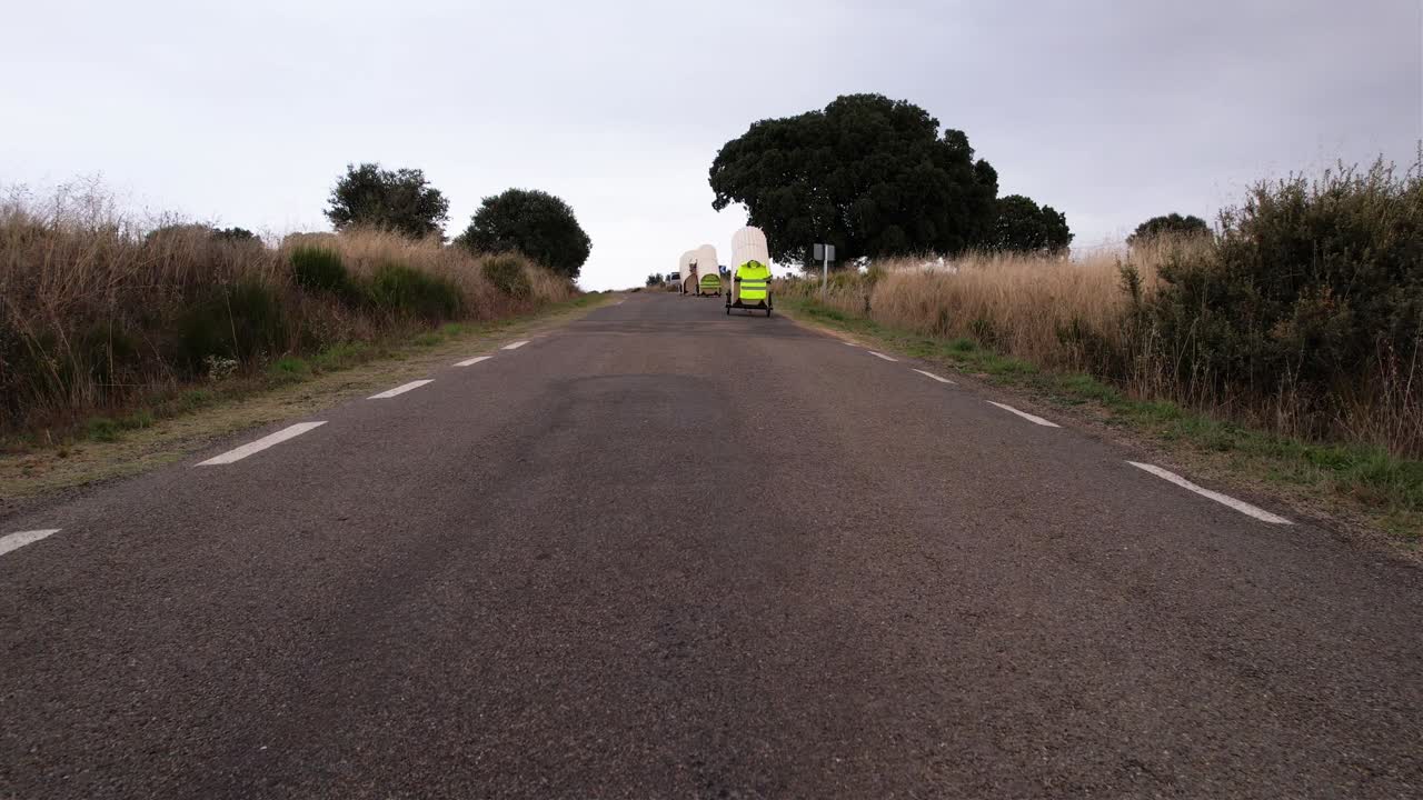Nomad family pulling small homes on wheels in countryside in Spain
