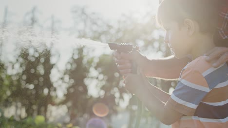 close up video of boy watering vegetables in the garden