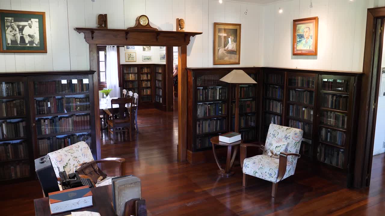 Inside a Historical Library Filled with Books and Portraits
