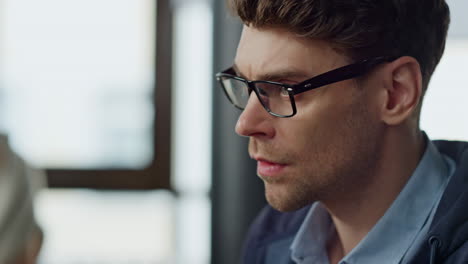 Thoughtful-analyst-looking-computer-screen-closeup.-Focused-it-manager-checking