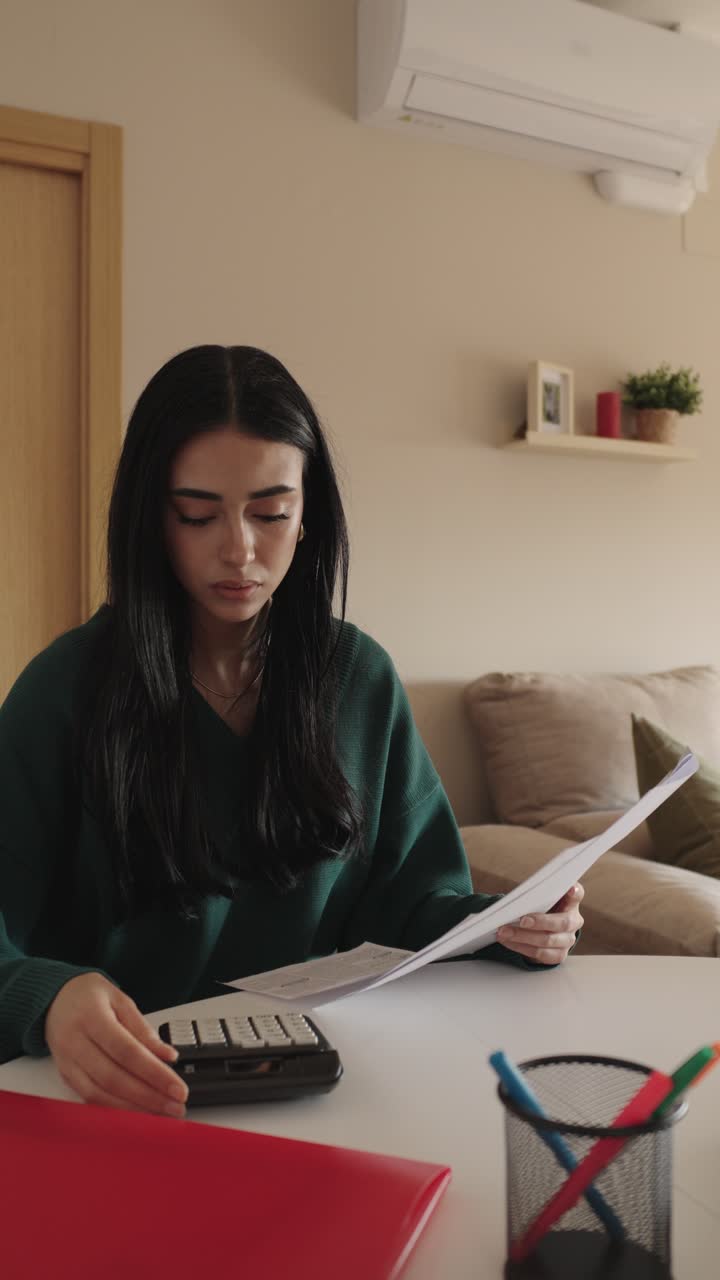 Woman Calculating Finances at Home
