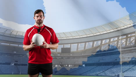 professional rugby player standing in front of a flag and stadium