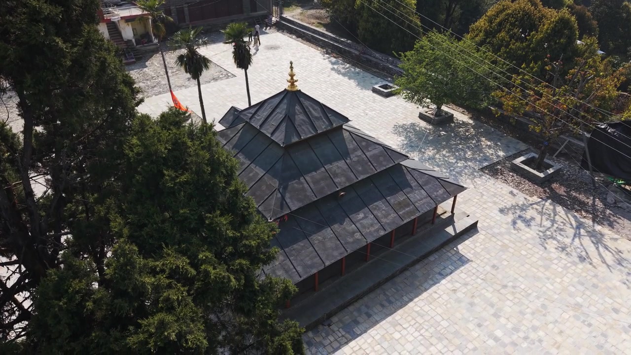 Aerial view of Resunga Temple in Tamghas, Gulmi, showcasing a hilltop religious site surrounded by forest and natural landscape.