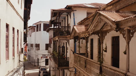 Aerial-view-of-Zanzibar-Stone-Town-old-narrow-street-with-wood-balconies-and-swinging-cables