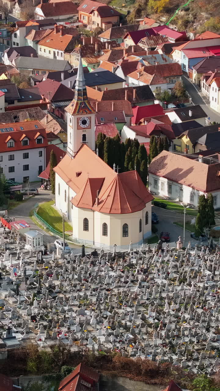 Aerial drone view of the St. Nicholas Church near a cemetery in Brasov, Romania. Vertical
