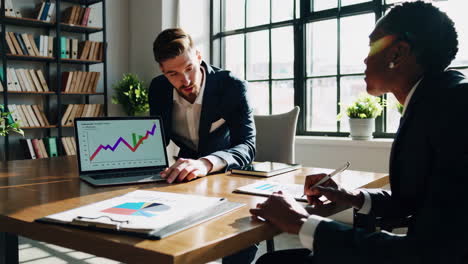 business colleagues in meeting discussing financial data