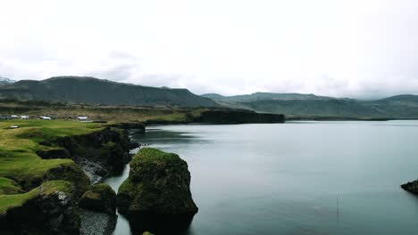 big blue lake at the foothill of a dormant volcano