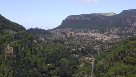 AERIAL:-View-on-Valldemossa-on-Mountains-in-Jungle-Forest-on-Tropical-Island-Mallorca,-Spain-on-Sunny-Day-Vacation,-Travel,-Sunny