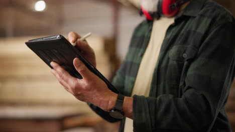 carpenter using tablet in workshop