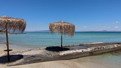 stunning beach scene in halkidiki, greece, with elegant sunbeds facing the crystal-clear turquoise sea. a perfect summer escape in the heart of the aegean.