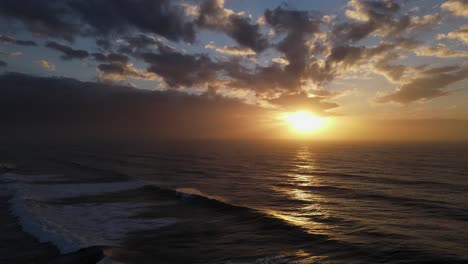 Aerial-shot-of-waves-crashing-onto-the-Israeli-coast-during-sunset