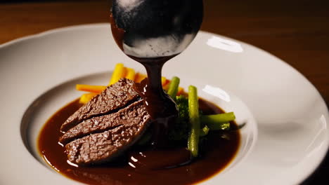 seared steak with rich brown sauce and vegetables