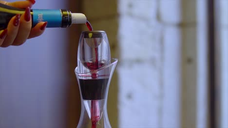 pouring red wine into decanter