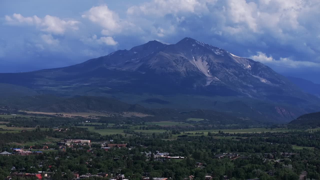 Mt Sopris Spring Creek Ranch Carbondale Roaring Fork River summer Colorado aerial drone June July Aspen Snowmass Rocky Mountain snow cap peaks Marble El Jebel Marble Basalt clouds sunny backwards