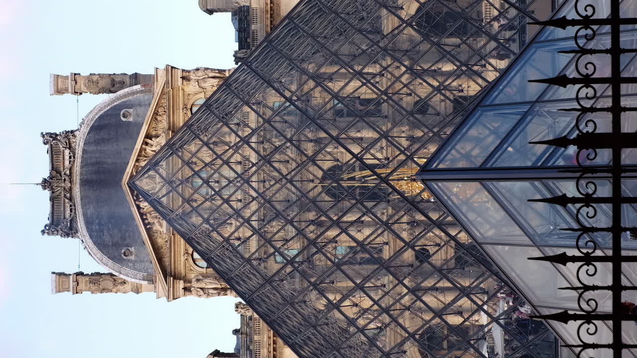 Paris, France - November 21, 2021: Front view of the Louvre Pyramid Museum in daylight. Vertical