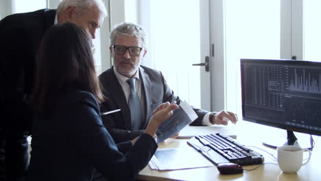 focused confident female financial advisor showing charts to her managers