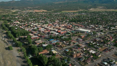 Aerial-cinematic-drone-mid-summer-downtown-Salida-Colorado-near-Buena-Vista-on-Arkansas-River-Riverside-Park-Scout-surfing-wave-mountain-biking-hiking-rafting-Rocky-Mountain-Bad-Fish-forward-movement