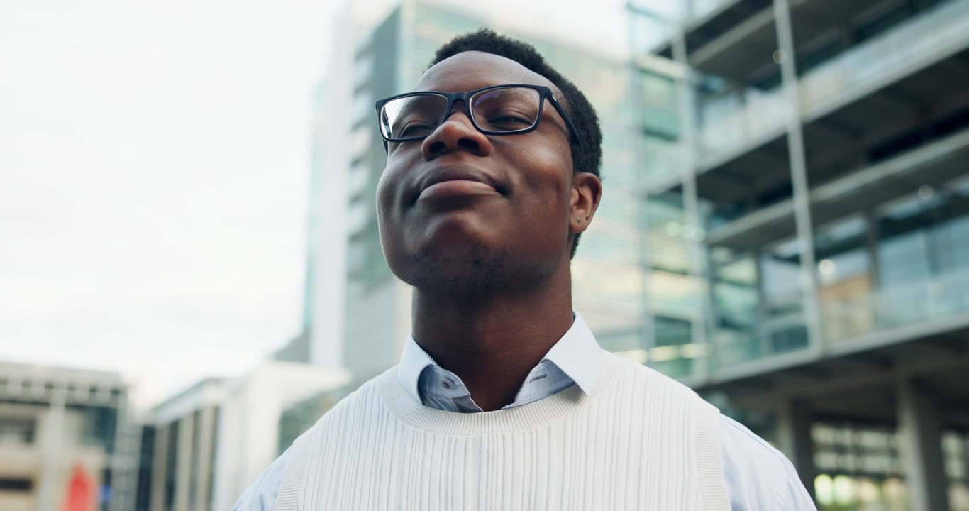 Young Professional Man Looking Upwards in Modern Urban Setting