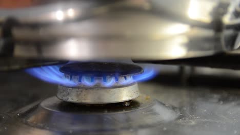 gas stove flame under blurred pot close up