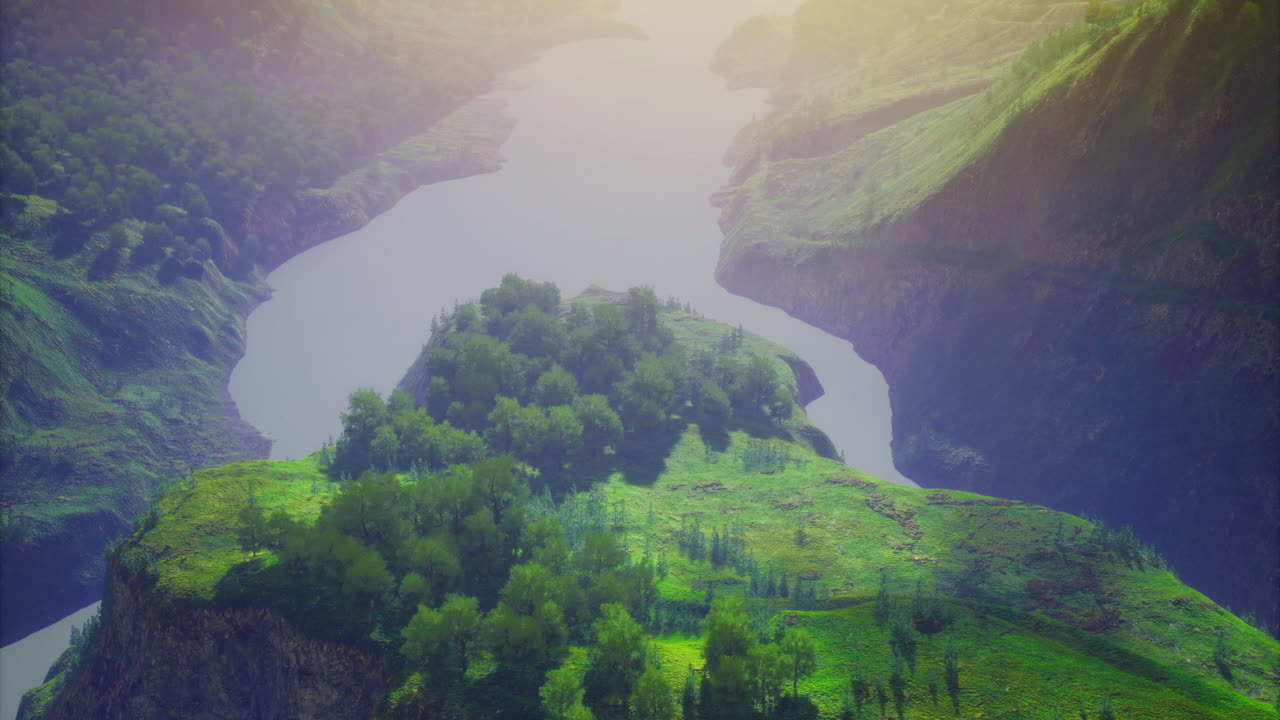 View of a lush river valley surrounded by steep green hills at sunset