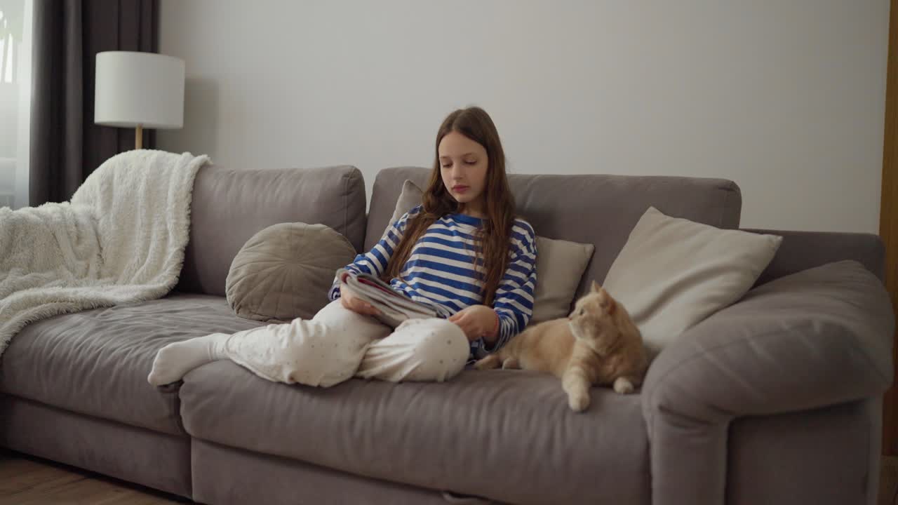 Girl relaxing on couch with cat