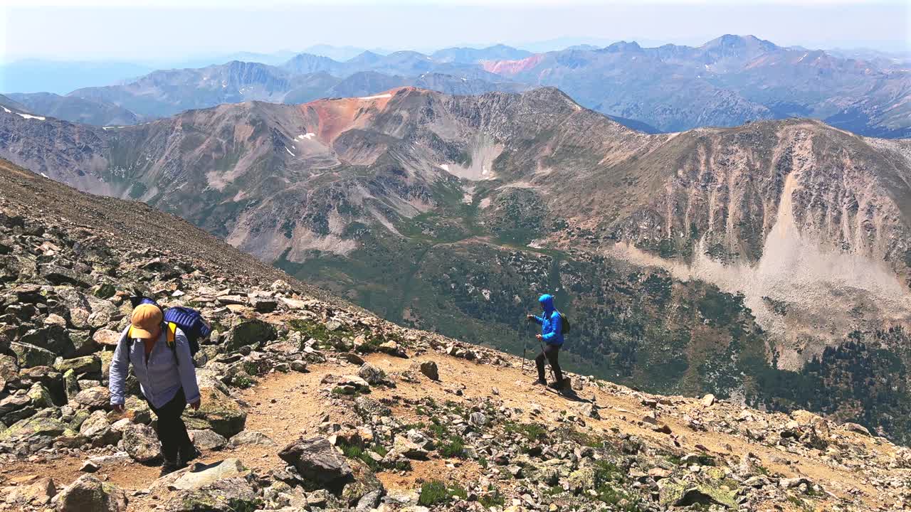 Hiking hikers switchback La Plata Peak 14er summit Sawatch Range 14er spring summer Rocky Mountains Colorado high alpine elevation above treeline Gulch Creek hiking trail morning blue sky pan left