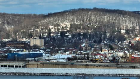 Long-aerial-zoom-of-Williamsport-PA-ski-town-on-snowy-day