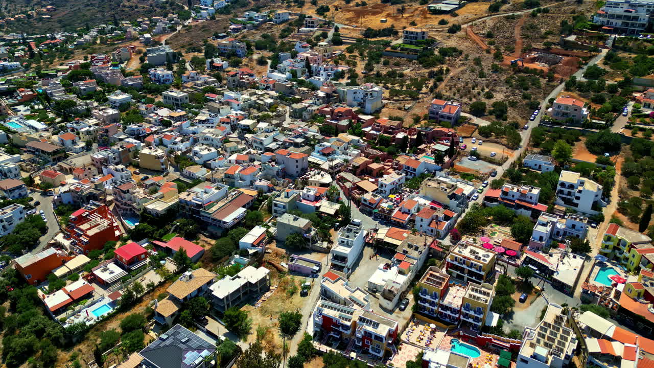 Piskopiano village with aerial view of traditional homes and rugged hillside terrain in Crete, Greece