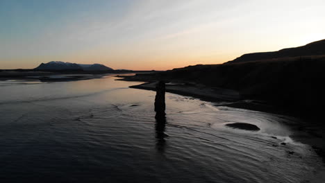 aerial view of hvitserkur, basalt rock in a shallow water by coast of iceland in twilight