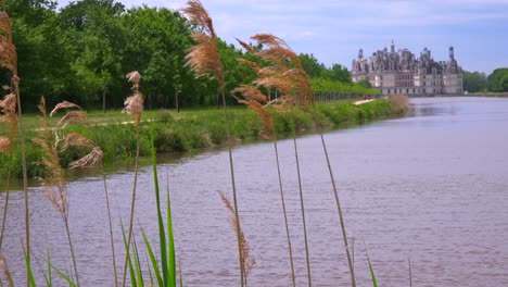 long view down a canal to the beautiful chateau of chambord in the loire valley in france 1