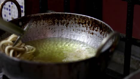 preparación para el festival recetas caseras de murukku. los bocadillos indios hechos durante el festival de deepavali en la india se fríen en aceite caliente.