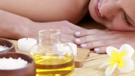 Woman-enjoying-a-herbal-compress-massage