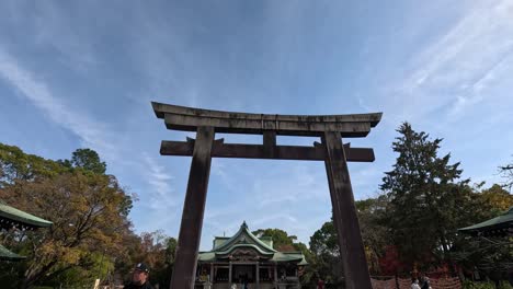 visitors walking through a traditional torii gate